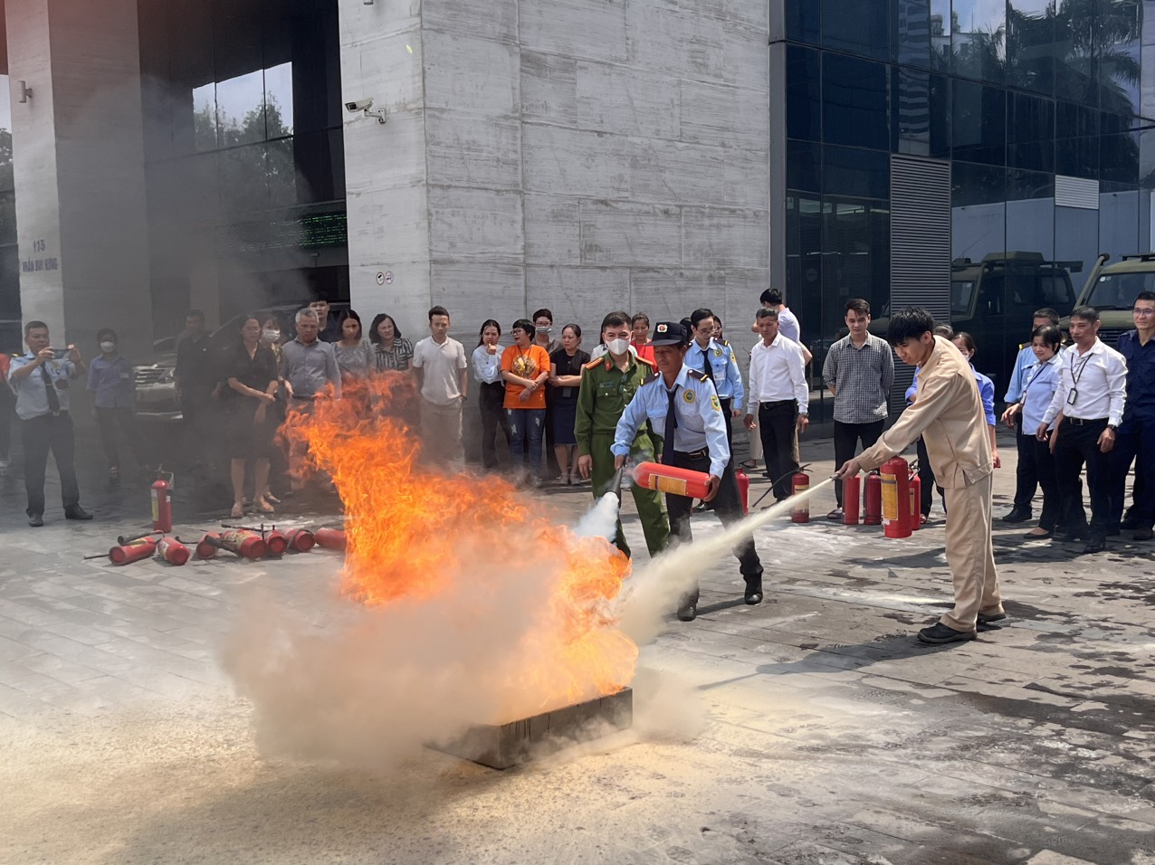 Các học viên thực hành sử dụng bình bột, bình khí CO2 để dập tắt đám cháy giả định